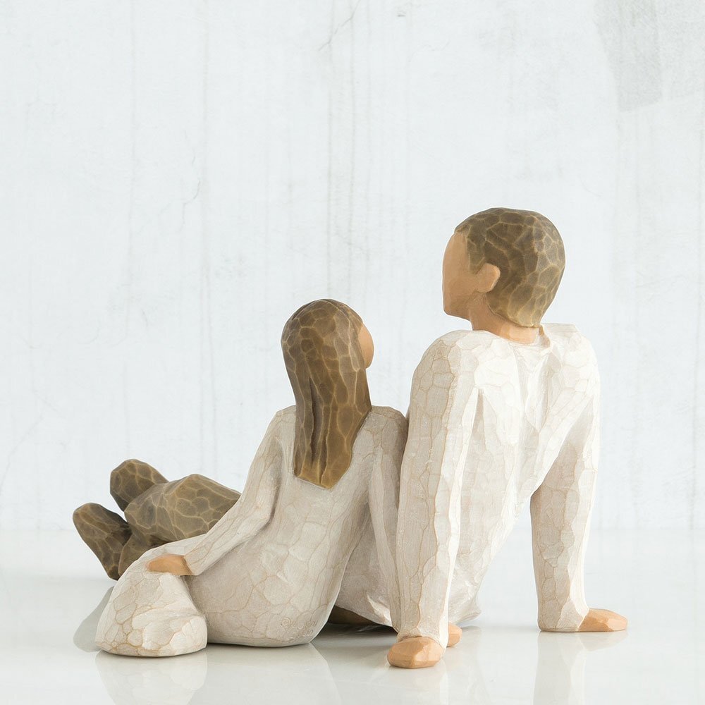 Father and Daughter Figurine by Willow Tree. Back View - Figure of seated male in cream shirt and dark pants, with young girl in cream dress seated by his side