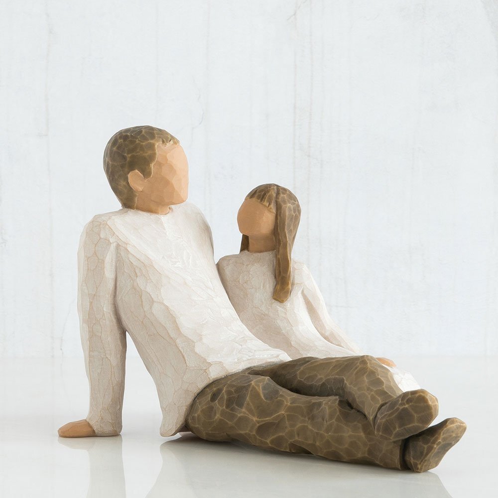 Father and Daughter Figurine by Willow Tree. Figure of seated male in cream shirt and dark pants, with young girl in cream dress seated by his side