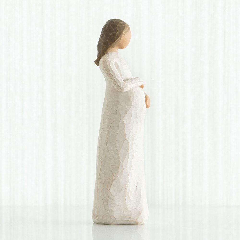 Cherish by Willow Tree. Side view - Standing pregnant female figure in cream dress, with both hands on belly