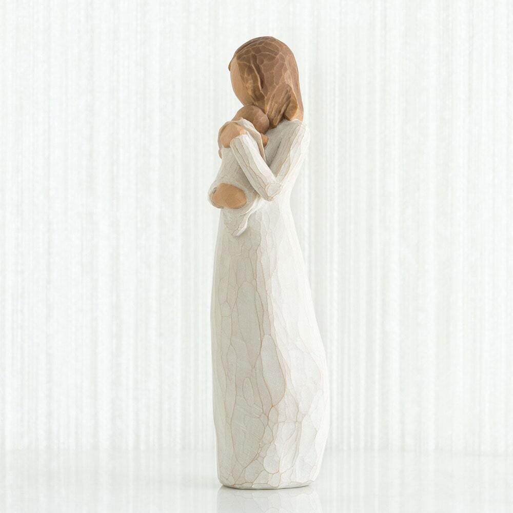 Angel of Mine by Willow Tree. Standing figure in cream dress, holding infant in cream blanket to her chest