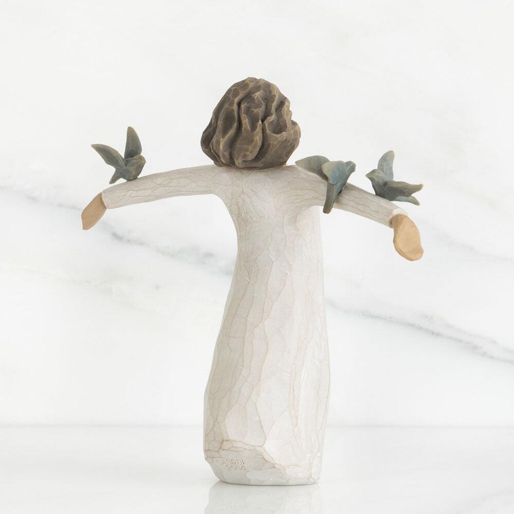 Happiness by Willow Tree. Back View - Standing figure in cream dress, with three bluebirds perched on outstretched arms