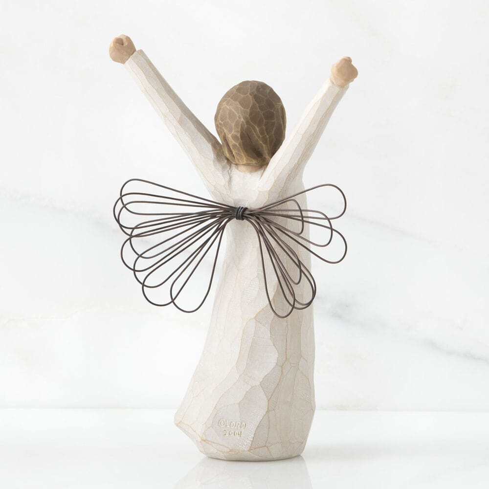 Back View: Standing angel in cream dress with wire wings, with both arms upraised