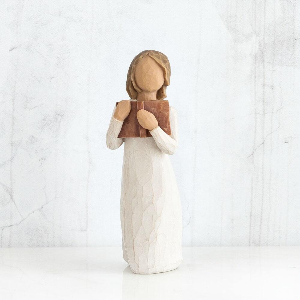 Love of Learning by Willow Tree. Standing figure in cream dress holding open book to her chest