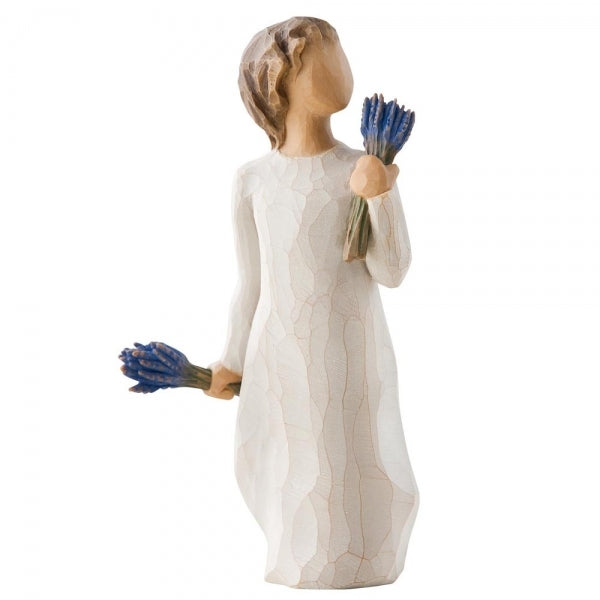 tanding female figure in cream dress, holding bundle of lavender flowers in one raised hand, and another bundle in other hand at her side