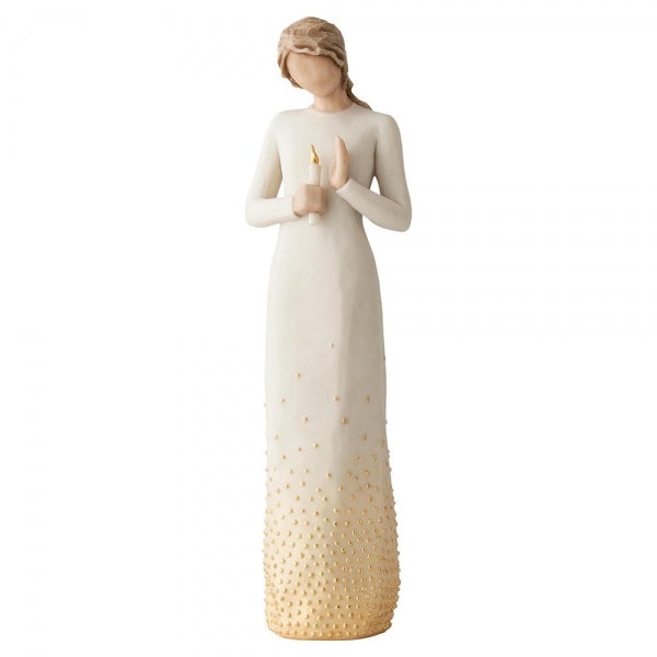 Standing figure in cream dress with elongated torso, holding candleholder with gold-leaf candle in her hands. Skirt of figure embellished with gold paint and gold-leaf dots